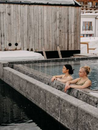 Two women in winter in the 42 degree hot onsen pool