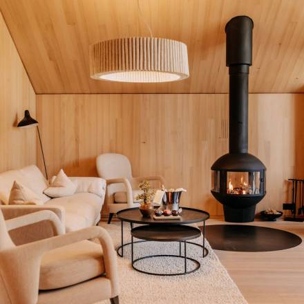 Modern suite with cosy living room and fireplace at Naturhotel Forsthofgut