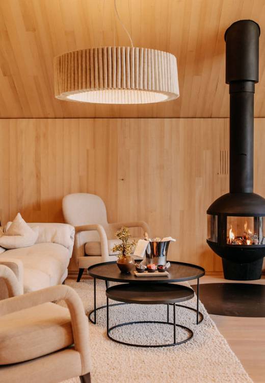 Modern suite with cosy living room and fireplace at Naturhotel Forsthofgut
