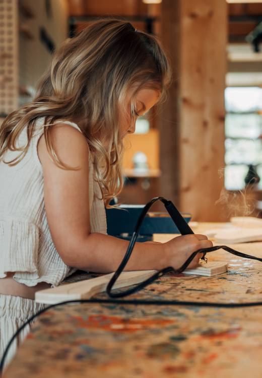 Forsthofgut Art Studio: Child crafting on a workbench