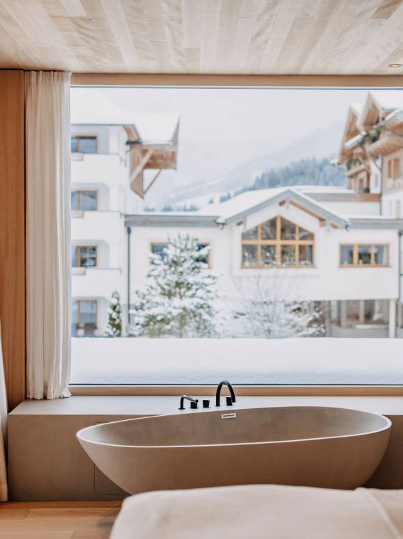 Free-standing bathtub in the master bedroom with a view of the winter landscape. 